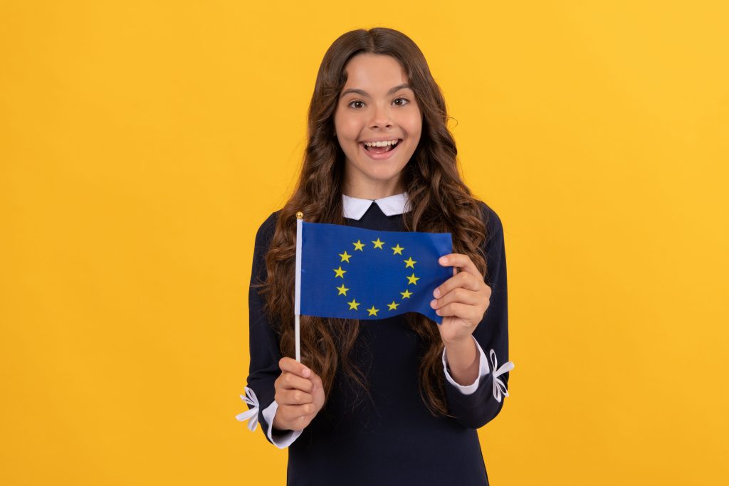 amazed kid hold european union flag yellow background, european union